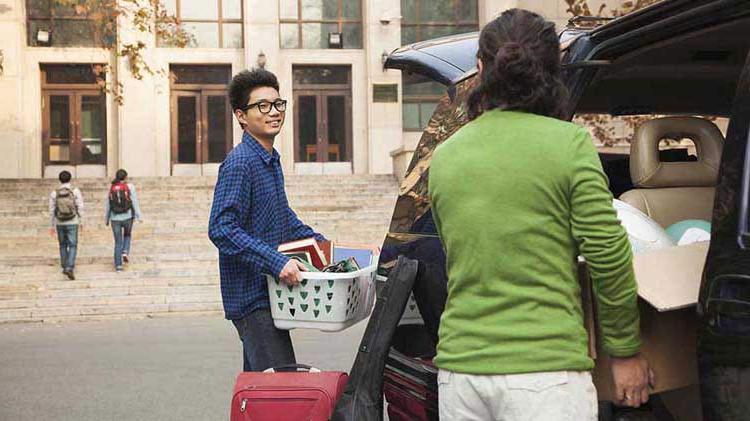 Mom helping son move into dorm