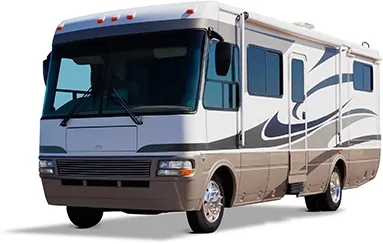 Looking down the front passenger side, the view of a white with teal-and-taupe trim RV.